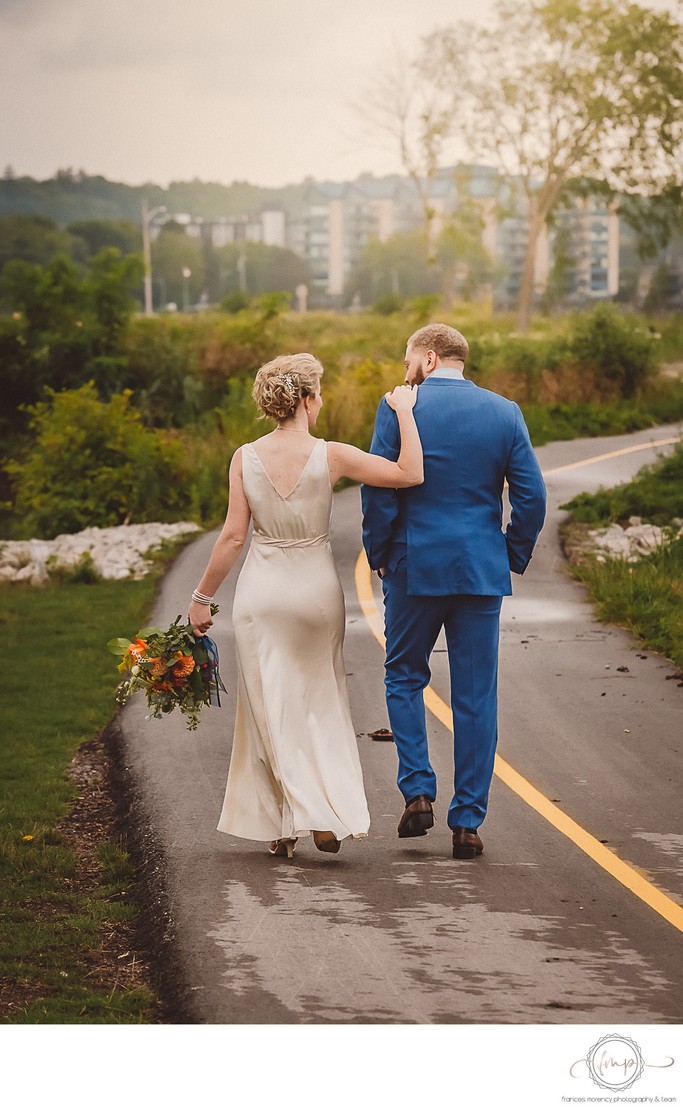Bride Walking with Hand on Grooms Shoulder in Owen Sound