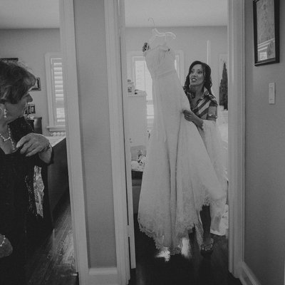 Bride Carries Dress While Mom Cries:  Photojournalism 