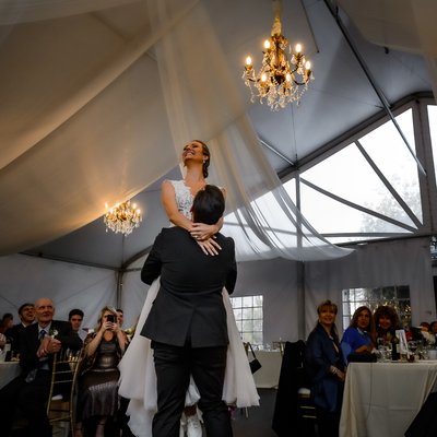Groom lifts Bride During First Dance
