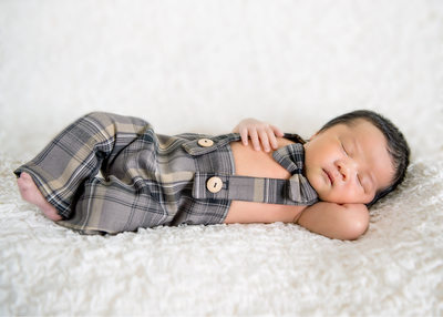newborn boy with brown suit pose photos pictures