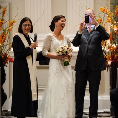 Groom pulls out iPhone at wedding 