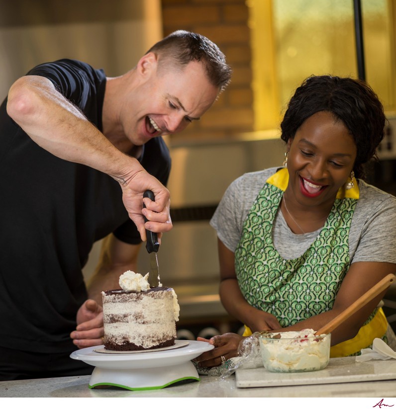 Temi showing Alex the ropes on the art of wedding cakes