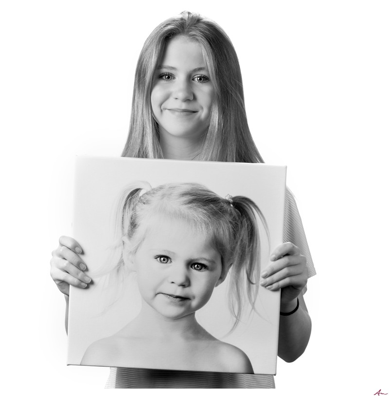 Family photo daughter with a canvas of her younger self