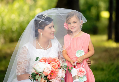 Bride and Flower Girl Under Veil 