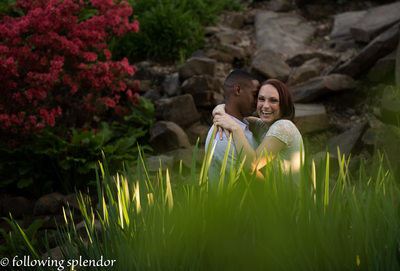 Engagement photos with girl laughing and beautiful flowers