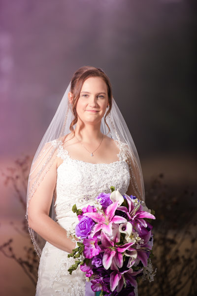 Bride with a beautiful bouquet of various purple flowers