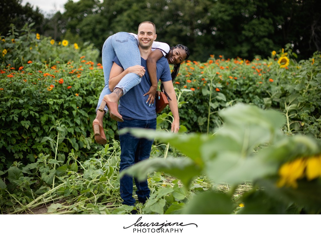Fun Engagement Photo in Sunflower Field