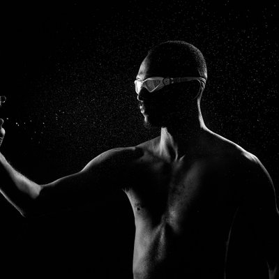 Sport studio portrait swimmer spraying water on face