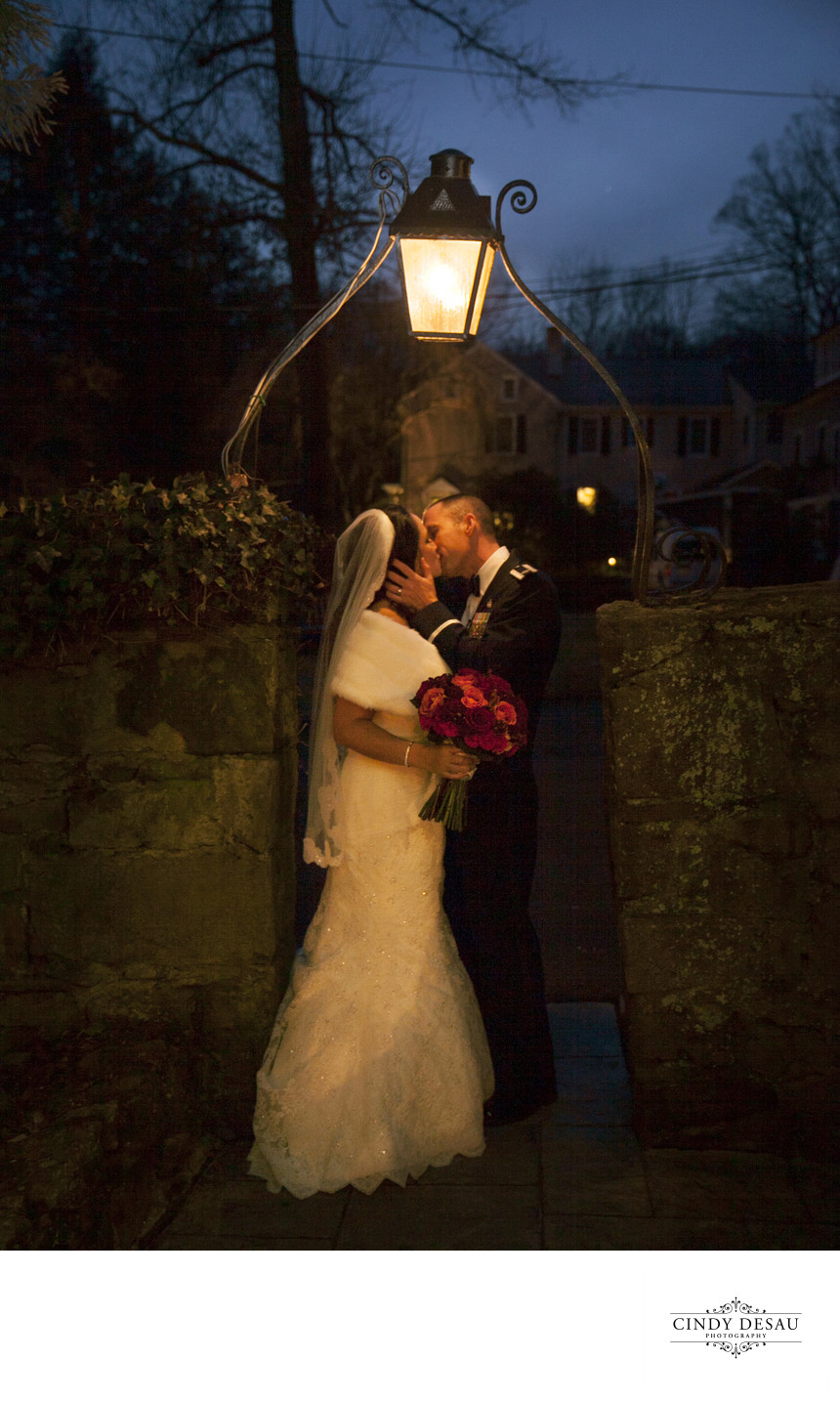 Holly Hedge Wedding Kiss in the Warm Glow of Dusk Photo