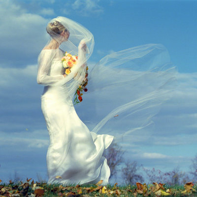 A Long Veil on a Windy Day Makes for a Dramatic Wedding Photo.
