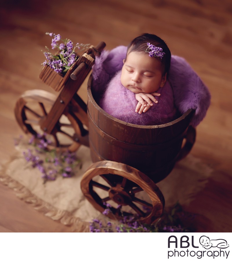 San Diego newborn photos in a studio, baby in tricycle