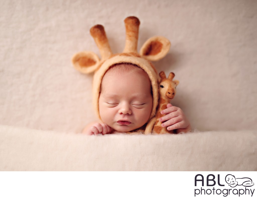 Baby with giraffe hat and toy