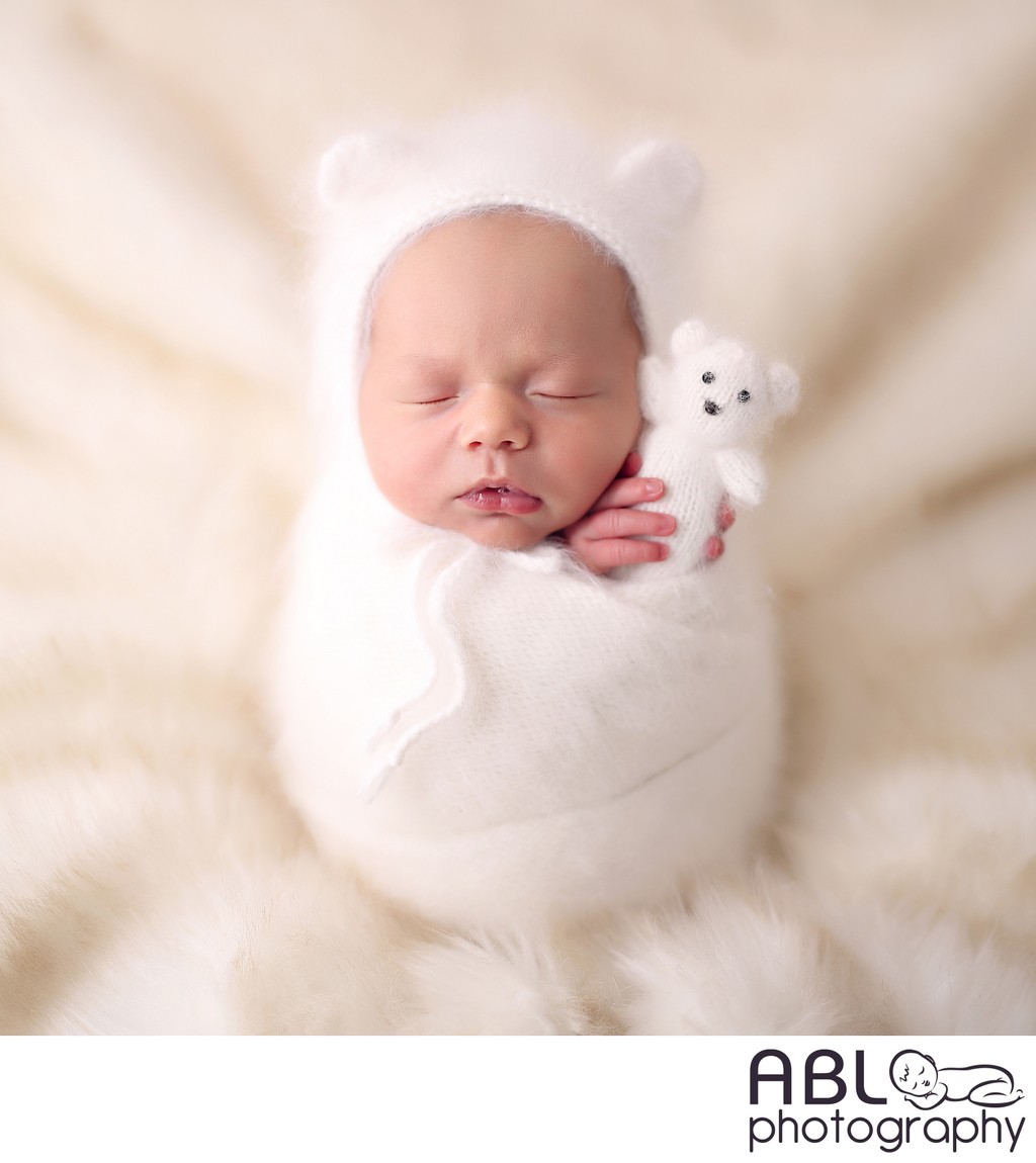 Wrapped baby with bear toy