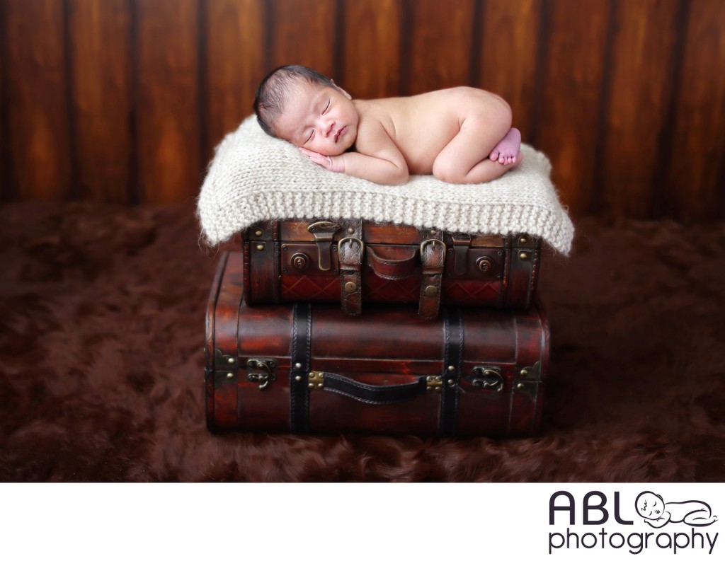 Baby posed on suitcases