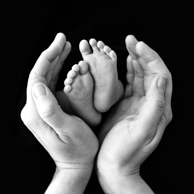 Hands holding baby feet
