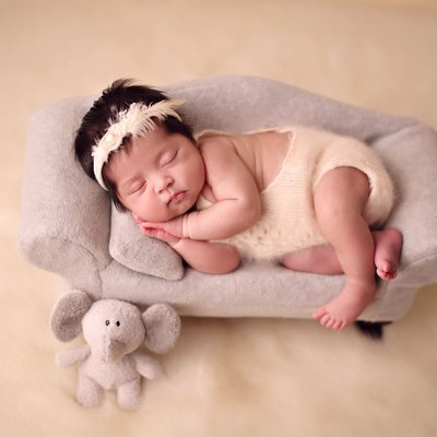 baby on gray sofa in La Jolla photography studio