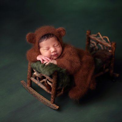 San Diego newborn pictures, baby bear on wooden bed