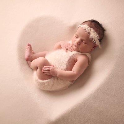 Baby in cream heart prop