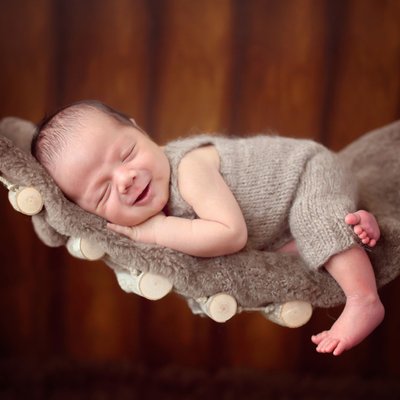 baby smiling on hammock