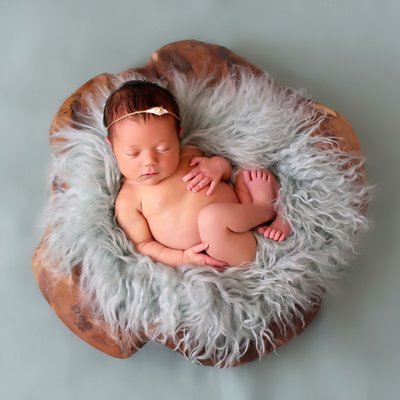 Newborn photography studio, baby on teal fur 