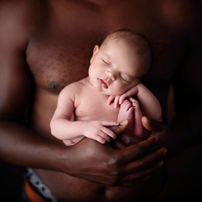 Father holding baby in arms