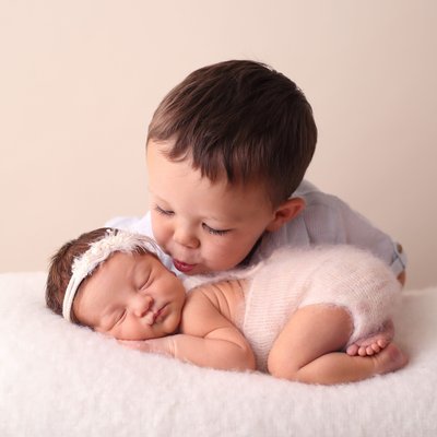 Small boy kissing his little sister