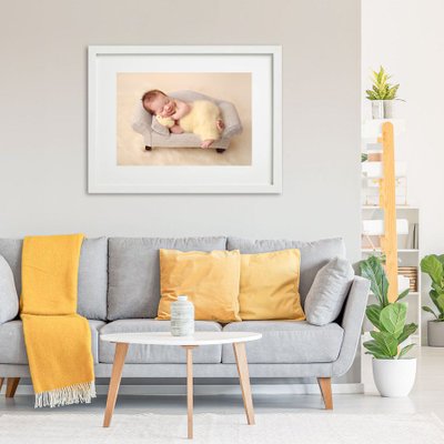 Wall art baby on gray sofa