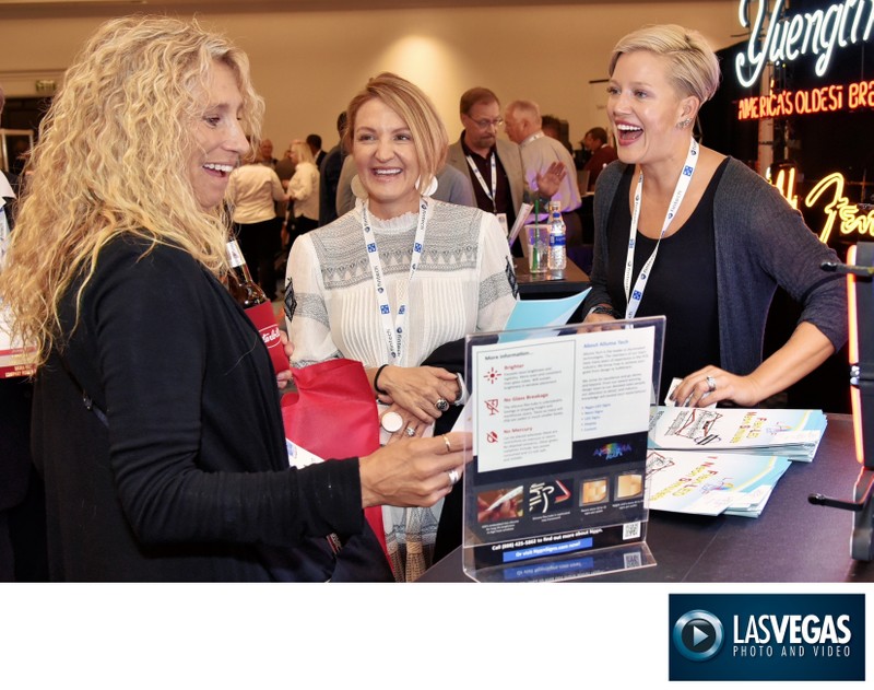 Tradeshow photography of ladies laughing and talking