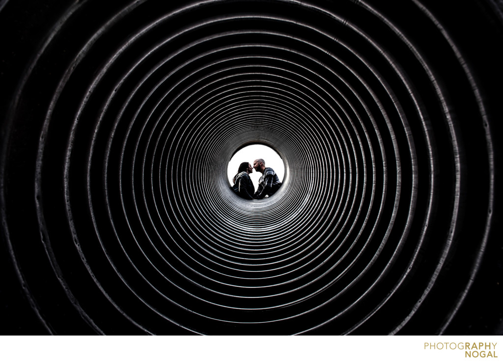 Couple kissing in the centre of a tunnel