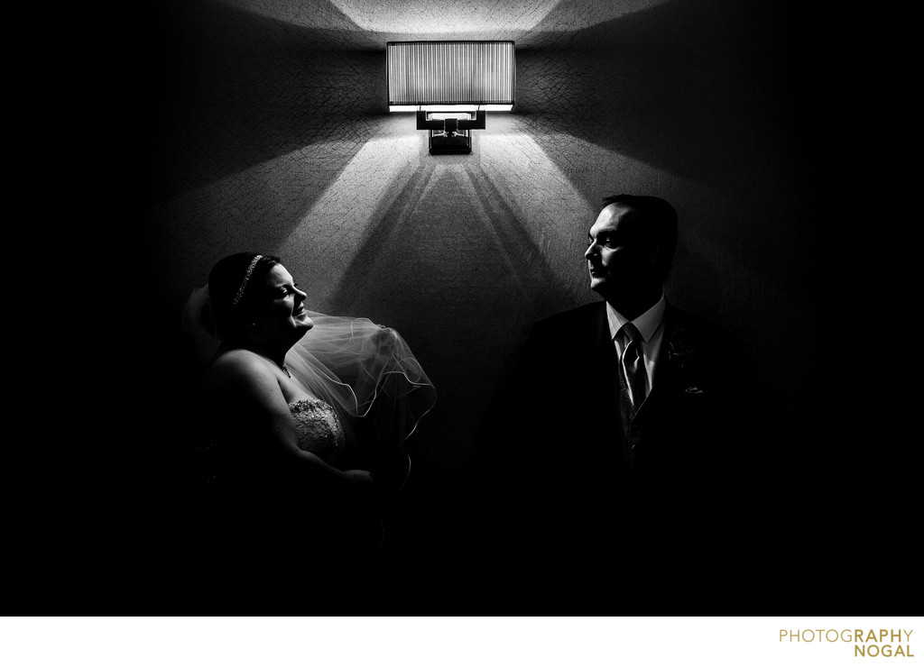 Bride and Groom Next to Light Fixture in Hotel