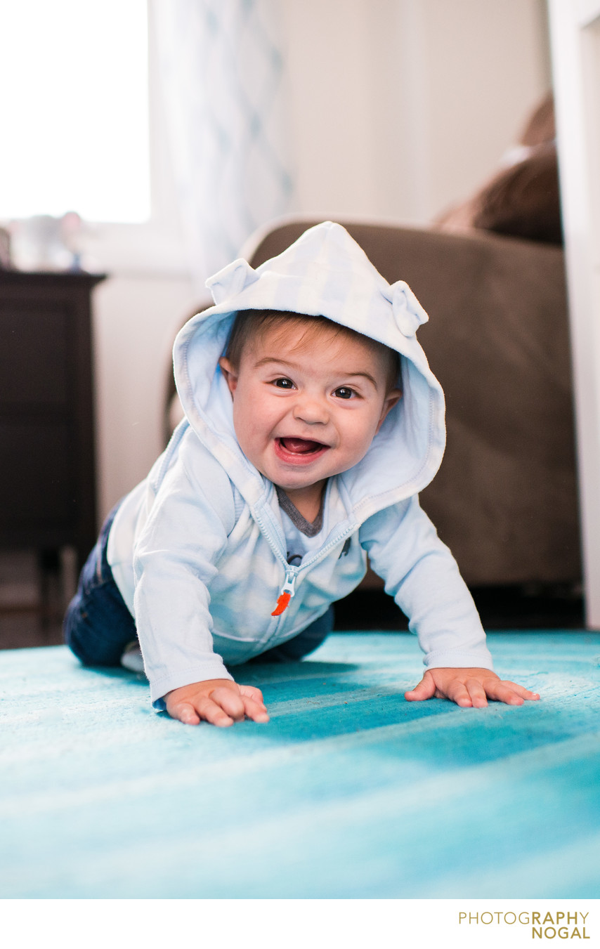 baby boy crawling on floor and smiling