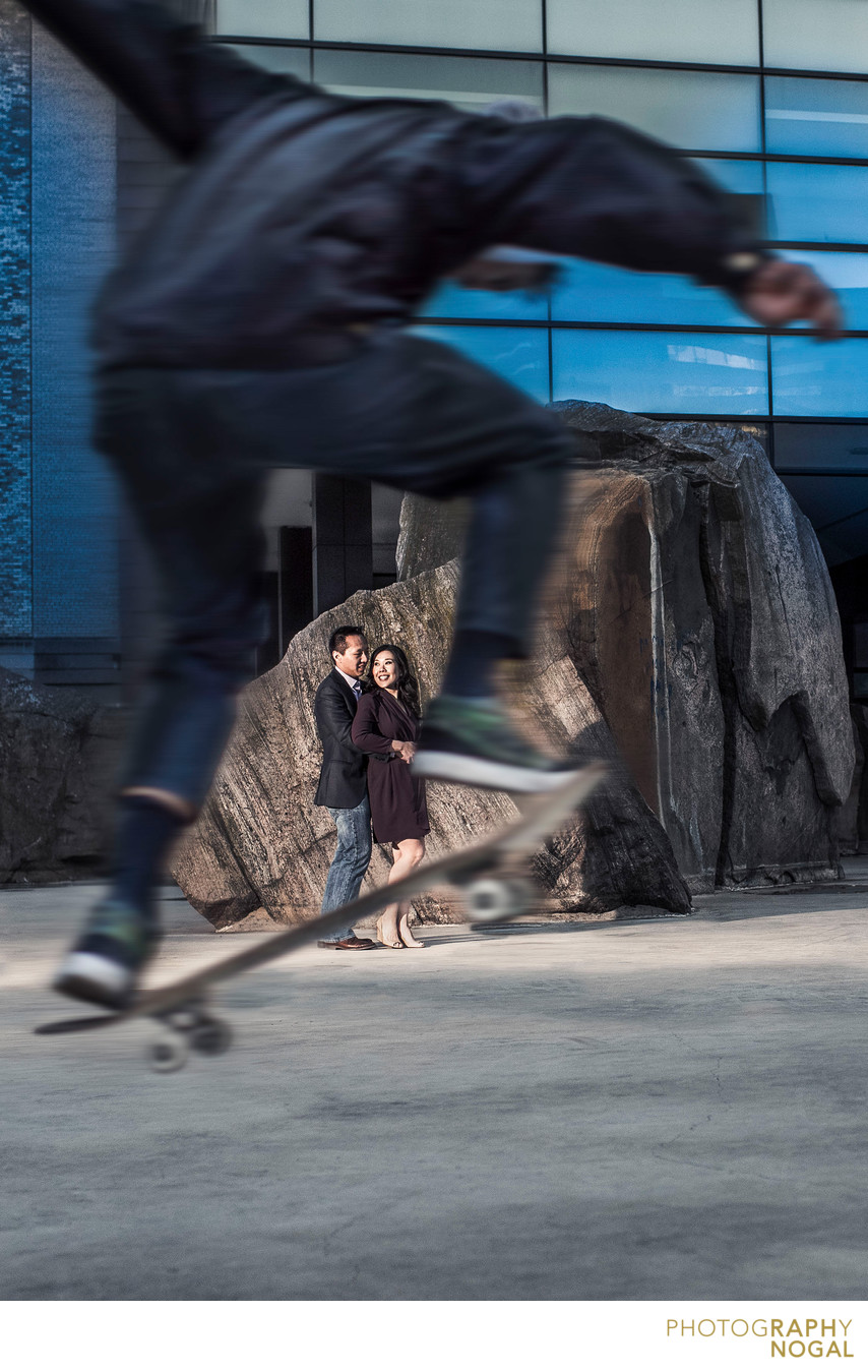 Couple with Skateboarder Jumping to Frame Them.
