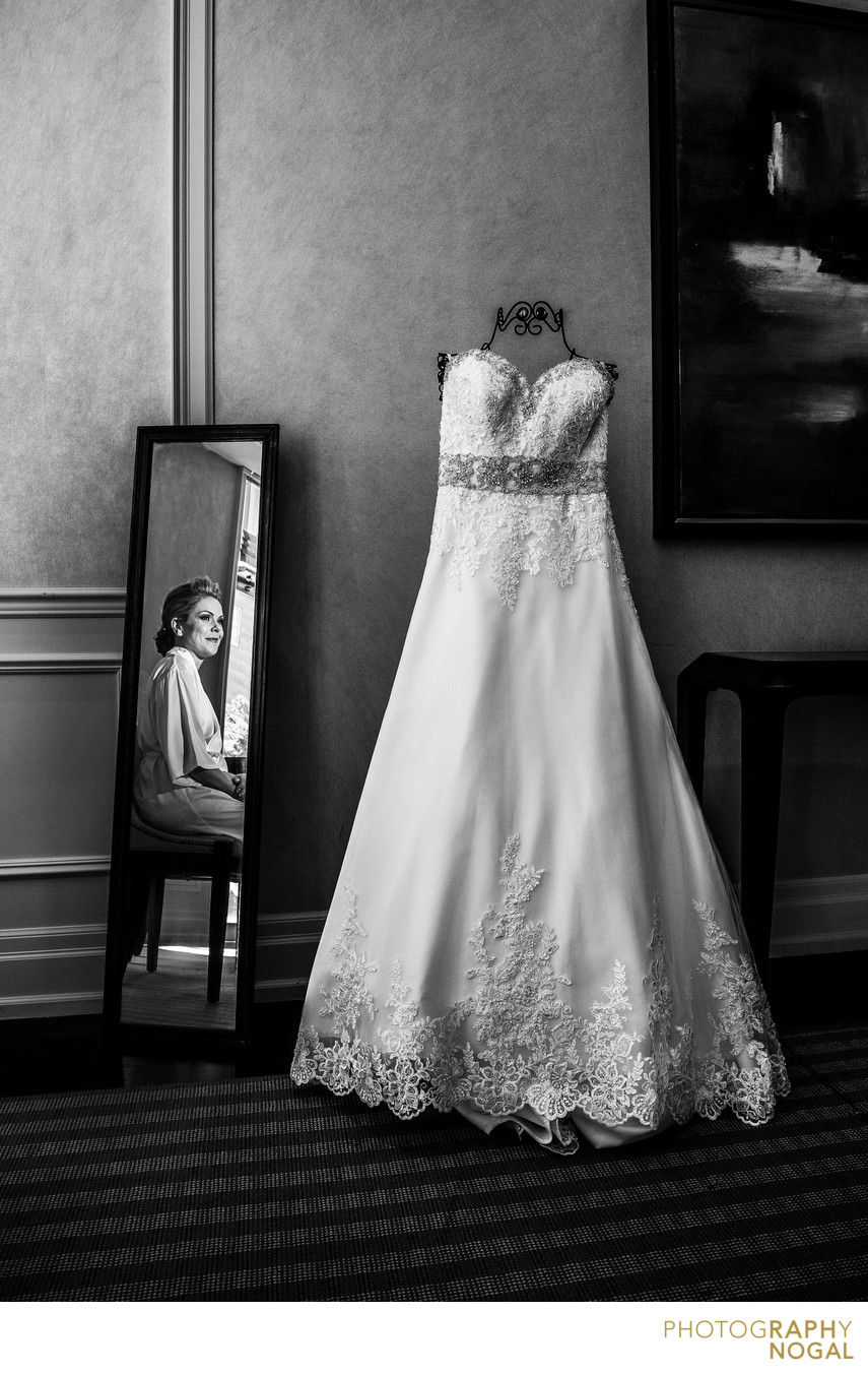 Bride in the Mirror Looking at Wedding Dress