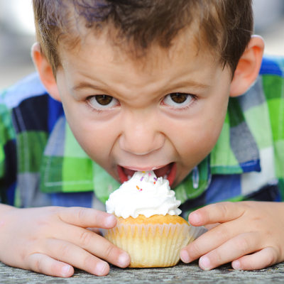 boy eating cupcake on his birthday