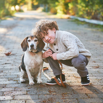 boy with beagle dog on a path in sam smith park