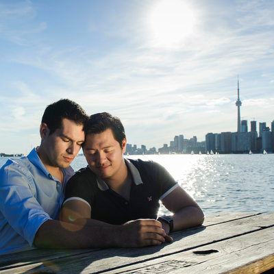 Couple at a picnic table, downtown Toronto background
