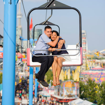 Engaged couple riding sky tram at CNE in Toronto