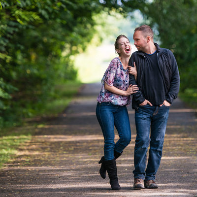 Couple Laughing While Walking In A Park