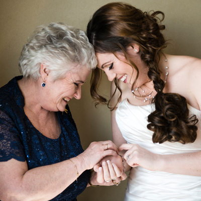 Bride and Mom Putting On Bracelet