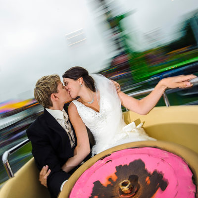 Bride and Groom Kiss at Orno Fair in Teacup Ride