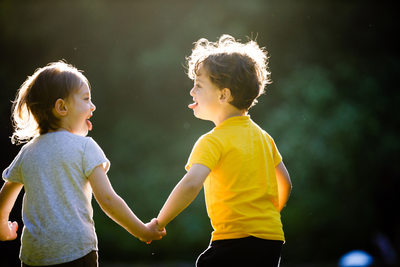 boy and girl hold hands and run together