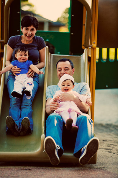 family-going-down-slide-playground
