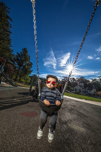 toddler in a swing sunglasses