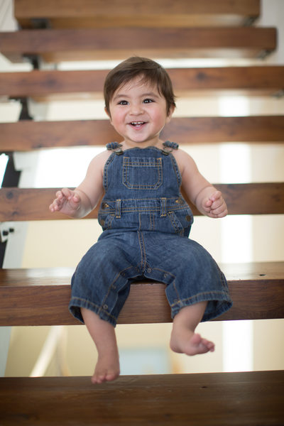baby in denim overalls