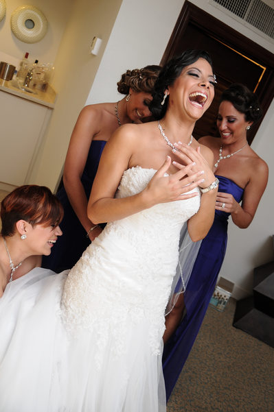 bride giggling in room getting ready