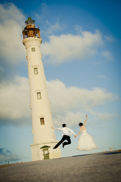  couple jumping lighthouse