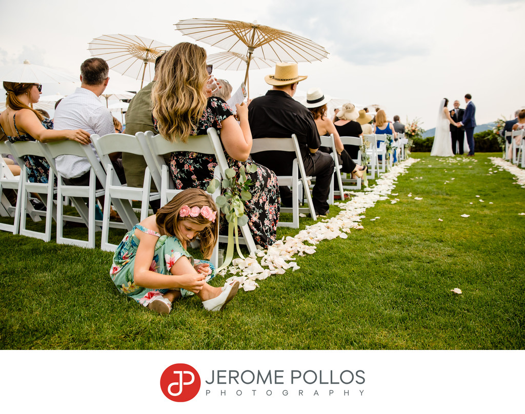 Young wedding guest entertains herself during ceremony