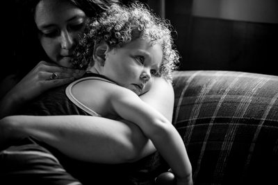 Mother comforts daughter family lifestyle portrait