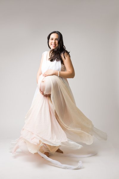 maternity photo shoot twirling fabric and radient smile
