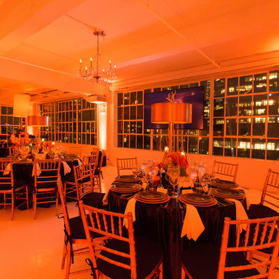 studio 450 bathed in orange for a Surprise 60th Birthday Party